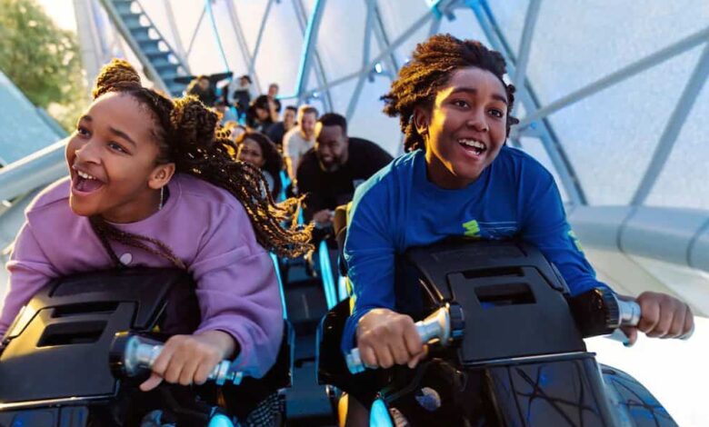 A young boy and young girl ride TRON Lightcycle/Run at the Magic Kingdom at Walt Disney World Resort