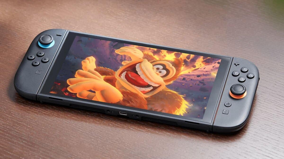 A handheld gaming console displaying an animated character in a dynamic pose with a fiery background. The console has blue and orange buttons and rests on a wooden surface.