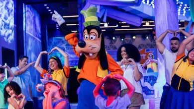 Young kids dance with Goofy at CommuniCore Plaza in EPCOT at Disney World.