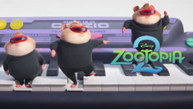 Three animated hamsters in black outfits and red sunglasses dance on an oversized keyboard. The "Zootopia 2" logo is displayed on the right side of the image.