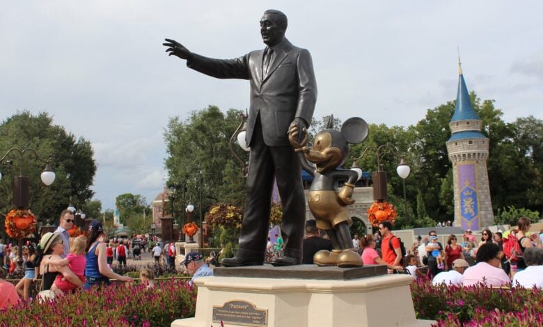 A bronze statue of Walt Disney and Mickey Mouse stands in front of Cinderella’s Castle at Magic Kingdom Park. Disney World ferryboat