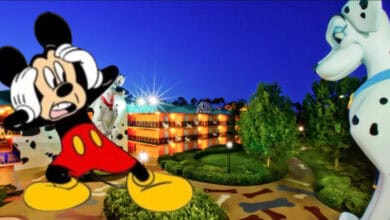 All star movie disney resort at night with mickey cartoon clipart standing in front with scared expression