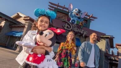 guests stand outside of World of Disney store in Disney Springs