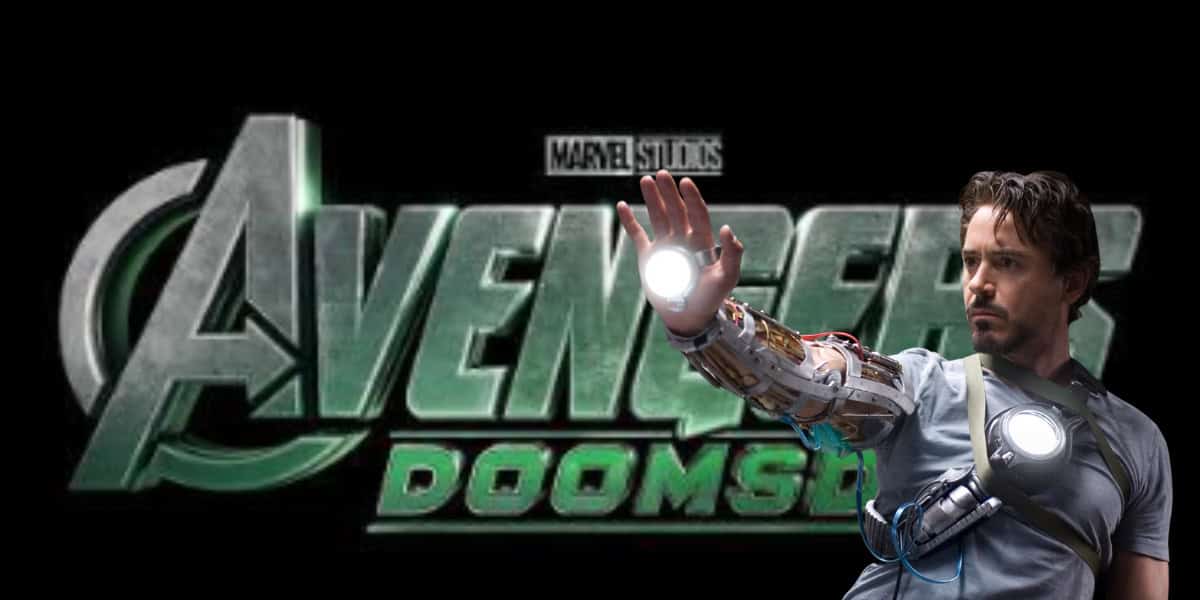 A man wearing a glowing mechanical arm stands in front of a stylized "Avengers: Doomsday" movie logo, holding up his hand with light shining from his palm.