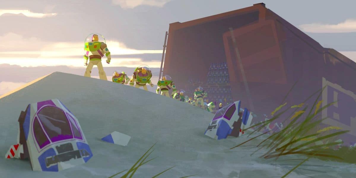 Several identical astronaut toy figures in white and green suits stand on a sandy hill near broken spaceship parts, with a large open container in the background under a cloudy sky.