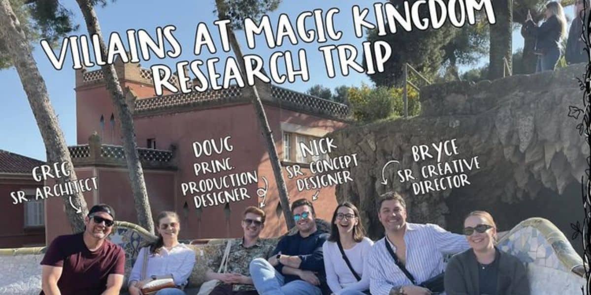 Eight people sit outdoors on a curved stone bench, smiling at the camera. Text above reads “Villains at Magic Kingdom Research Trip,” with names and job titles labeling each person. A pink building and trees are in the background.