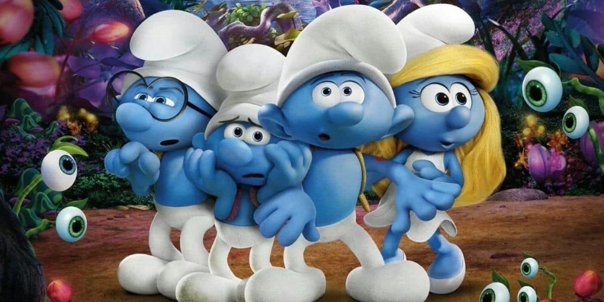 Four animated blue Smurf characters, including one with glasses and one with long blond hair, stand close together looking frightened in a colorful, mysterious forest with large eyes peering at them.