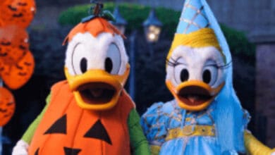 Donald Duck dressed as a jack-o'-lantern and Daisy Duck as a princess at Halloween. Mickey’s Not-So-Scary Halloween Party ride overlays 2026