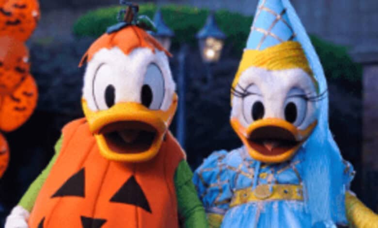 Donald Duck dressed as a jack-o'-lantern and Daisy Duck as a princess at Halloween