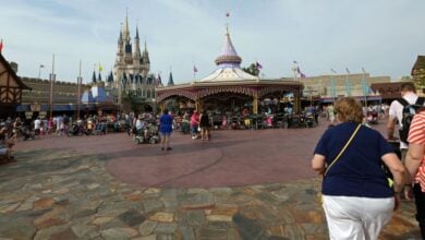 People walking through Fantasyland at Magic Kingdom Park.