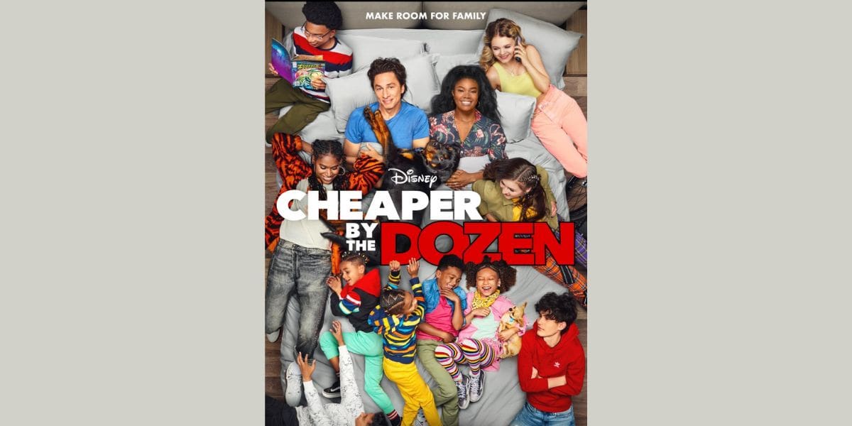 A diverse family of twelve smiles and laughs together on a bed. The Disney logo appears alongside the bold white and red title, "Cheaper by the Dozen." Above, the tagline reads, "Make room for family.