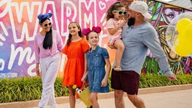 smiling family walking through Disney Springs to shop