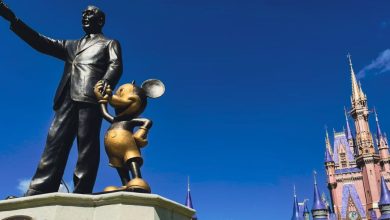 A bronze statue of Walt Disney and Mickey Mouse at Magic Kingdom