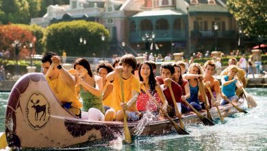 A group of people sit in a large canoe at Disneyland