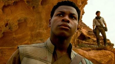 Finn (John Boyega) in front of rocks in desert