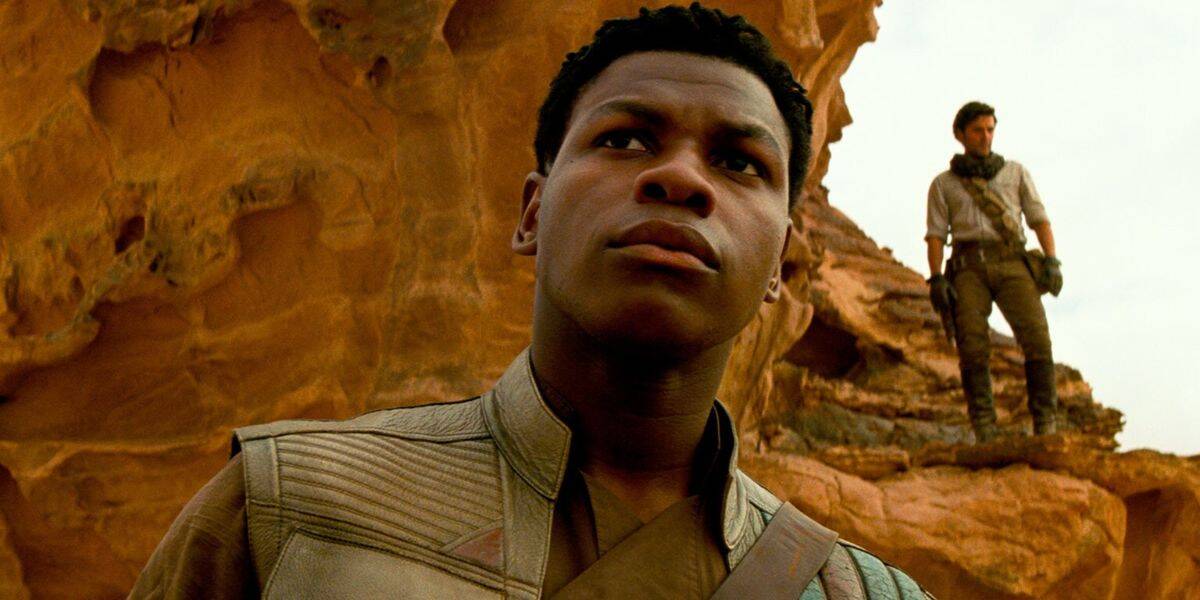 Finn (John Boyega) in front of rocks in desert