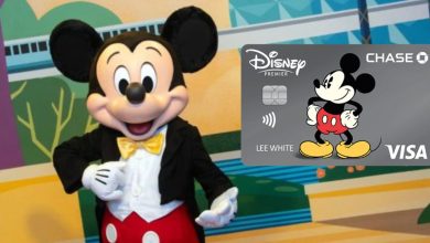 Mickey Mouse stands smiling in front of a colorful background. Next to him is a Disney Premier Visa credit card featuring an image of Mickey Mouse and the Chase and Visa logos.