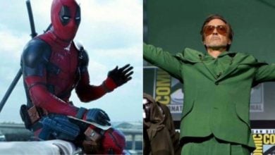 On the left, a person in a red and black superhero costume with swords on their back; on the right, a person in a green suit with arms outstretched, standing on a stage at a convention.