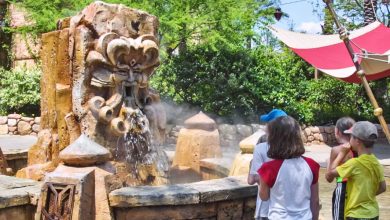 children interact with talking mystic fountain in universal's lost continent in islands of adventure