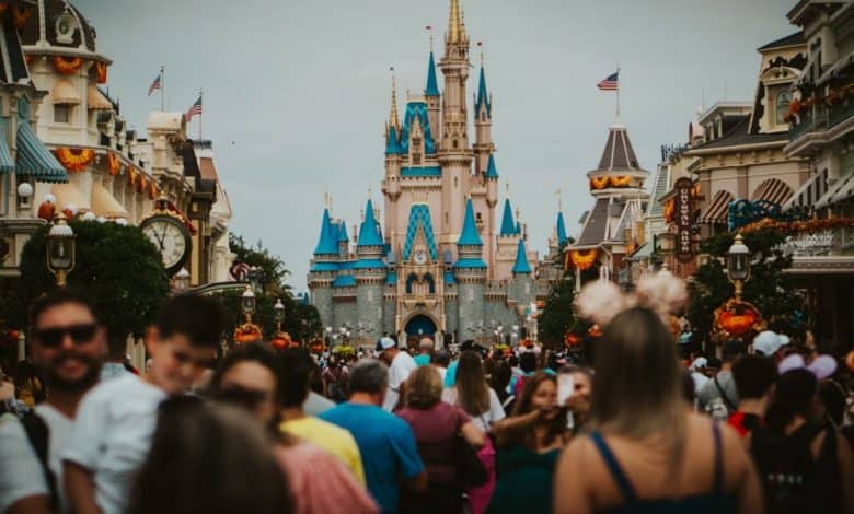 A large crowd of people walk along Main Street in Walt Disney World Resort