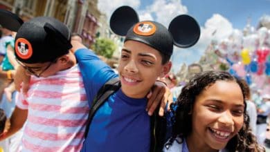 three kids walk through Main Street in Disney World