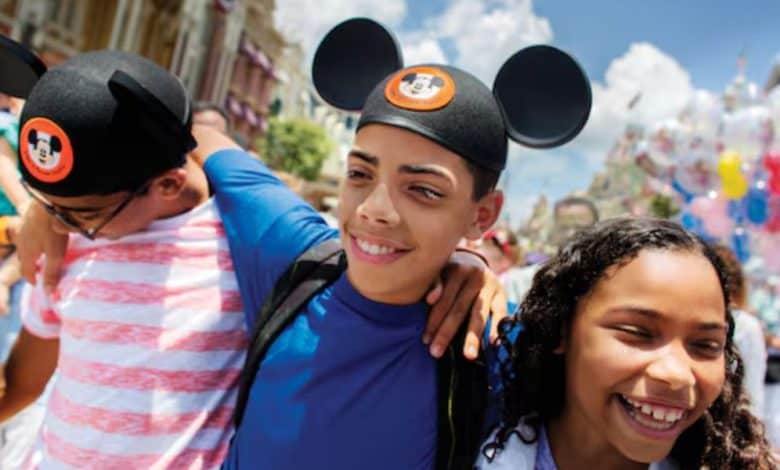 three kids walk through Main Street in Disney World