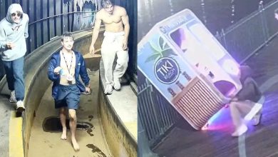 Three young men, two shirtless, walk through a water park slide area at night. On the right, a security camera image shows two people tipping over a large Tiki-themed drink stand on a boardwalk.