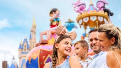 Family at Disney World with Festival of Fantasy parade in the background