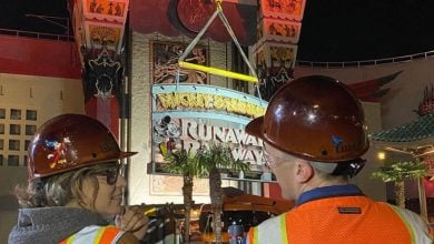 Walt Disney Imagineers in front of Mickey & Minnie's Runaway Railway
