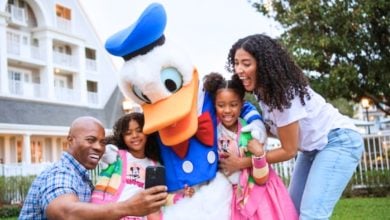 A family with Donald Duck at Disney World. Disney World ticket prices