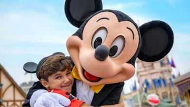 child hugging Mickey Mouse at Walt Disney World