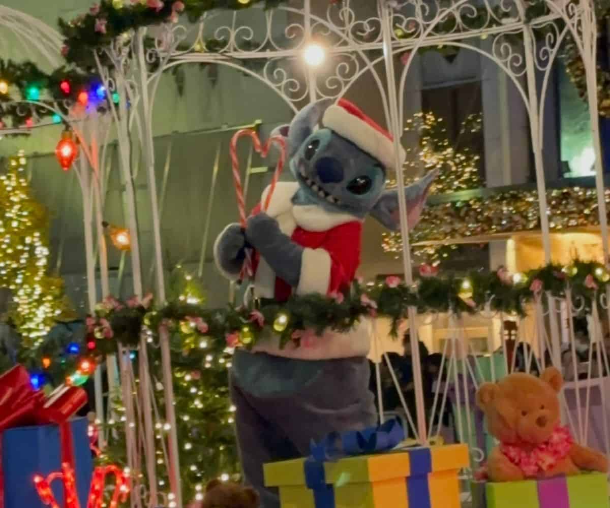 Stitch dressed as Santa poses with candy canes during the Magnificent Mile Lights Festival parade