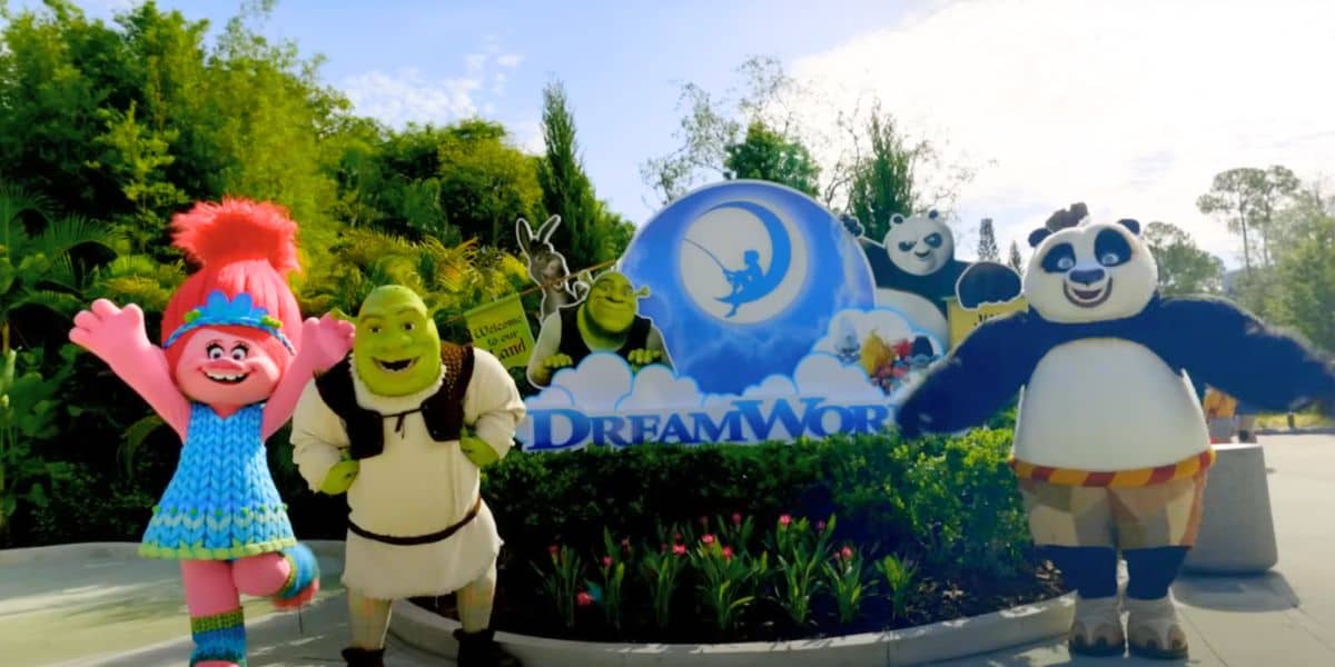 Shrek, Poppy, and Po in front of Universal Dreamworks Land sign