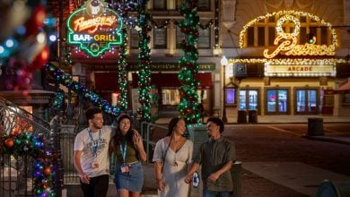 Guests walk through Universal Studios Florida decorated for Christmas