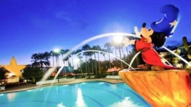 A large statue of Sorcerer Mickey Mouse sprays water at Disney's All Star Resort hotel