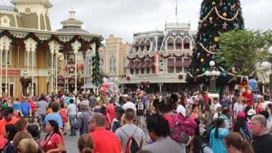Disney World's Main Street Christmas tree surrounded by crowds