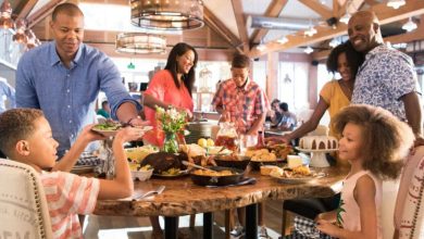 A family enjoys a meal together, laughing and relaxing in the vibrant, welcoming atmosphere of Disney Springs.