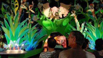 Guests riding through a jungle scene on "it's a small world"