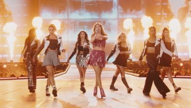 Taylor Swift singing onstage with dancers at The Eras Tour