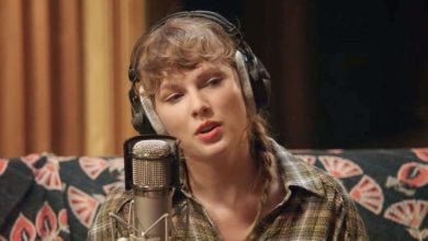 Taylor Swift singing into a microphone