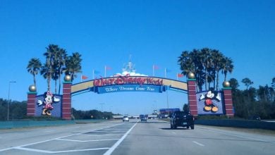 Walt Disney World entrance arch featuring Mickey and Minnie.