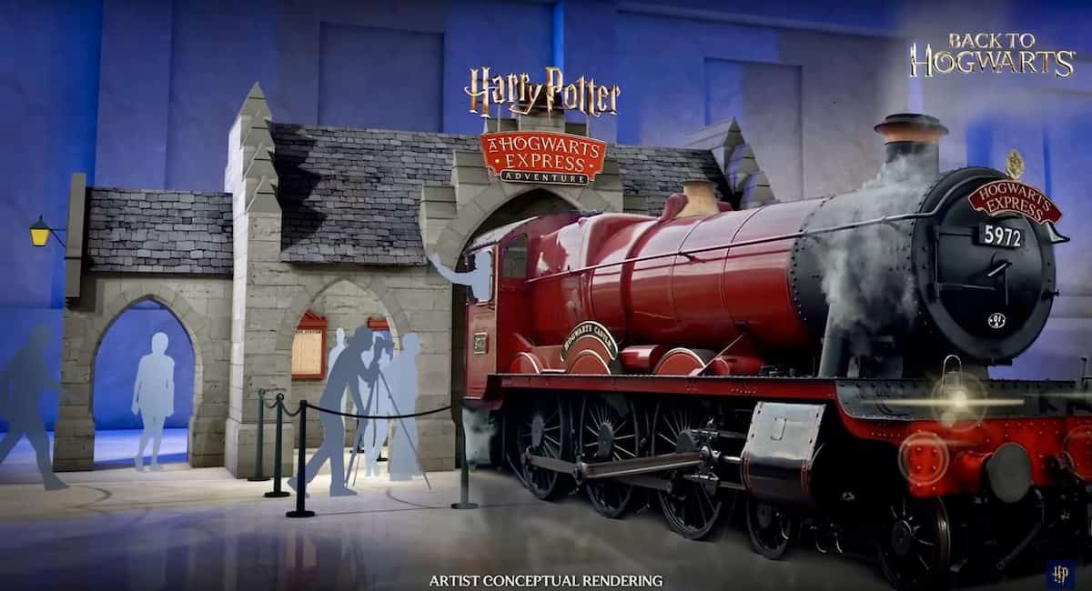 The red Hogwarts Express pulls into Hogsmeade Station under iconic Harry Potter signage, as excited guests gather nearby.