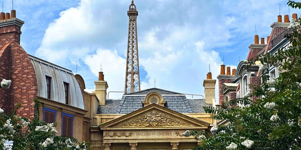 Eiffel Tower and Parisian facades evoke EPCOT’s France Pavilion, with an attraction temporarily closed beneath a cloudy sky.