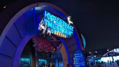 Hyperspace Mountain’s neon-blue entrance shines at night at Hong Kong Disneyland