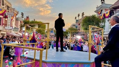 Josh DโAmaro addresses Disney fans in Disneyland as Bob Iger stands nearby