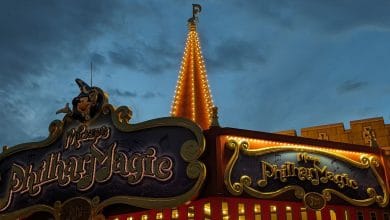 Mickey's PhilharMagic sign glowing at dusk at Tokyo Disneyland