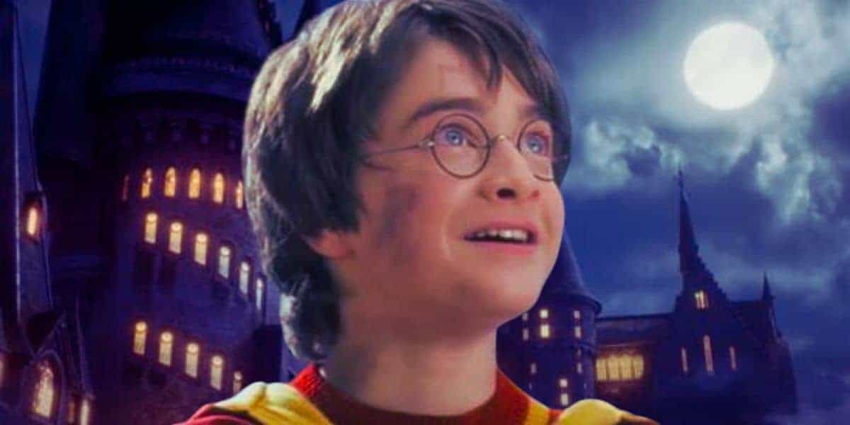 Harry Potter (Daniel Radcliffe) smiling during Quidditch in 'Chamber of Secrets' against the "Hogwarts Legacy" castle at night backdrop