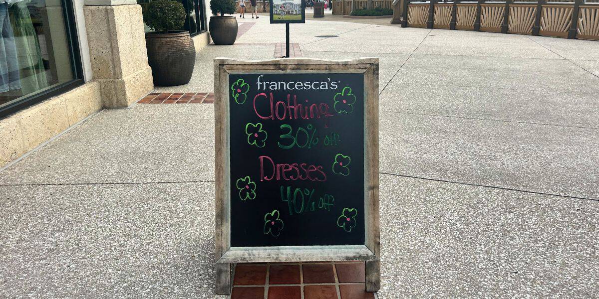 Chalkboard at Disney Springs: francesca’s Clothing 30% off, Dresses 40% off—last-chance deals with floral art before closing.