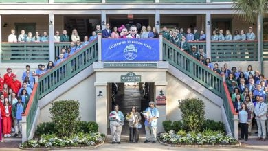Fans gather at a Disney Resort entrance with a “30 Magical Years” banner, joined by Disney characters for a festive DVC birthday.