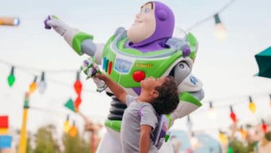 a young guest poses with Buzz Lightyear in Toy Story Land in Disney's Hollywood Studios park